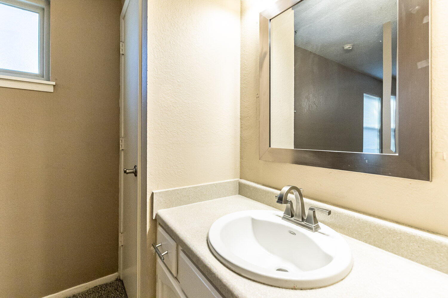 4737 48th Street Lubbock, TX 79414 - Photo 33 of 34 a bathroom with a sink and a mirror