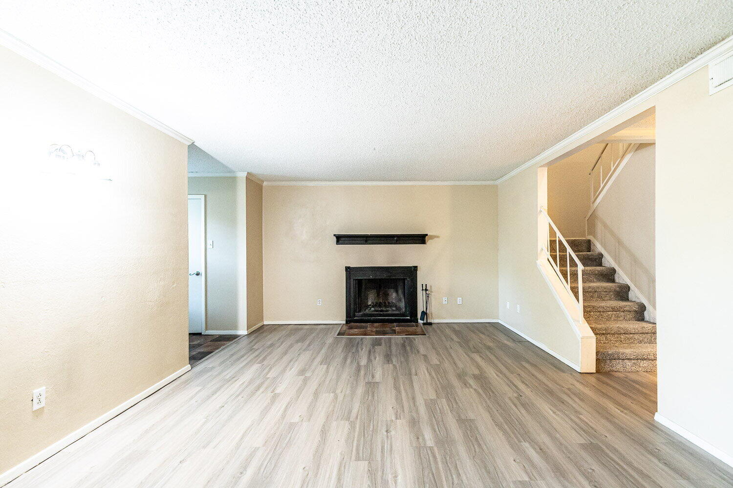 4737 48th Street Lubbock, TX 79414 - Photo 4 of 34 a view of a livingroom with wooden floor and a fireplace