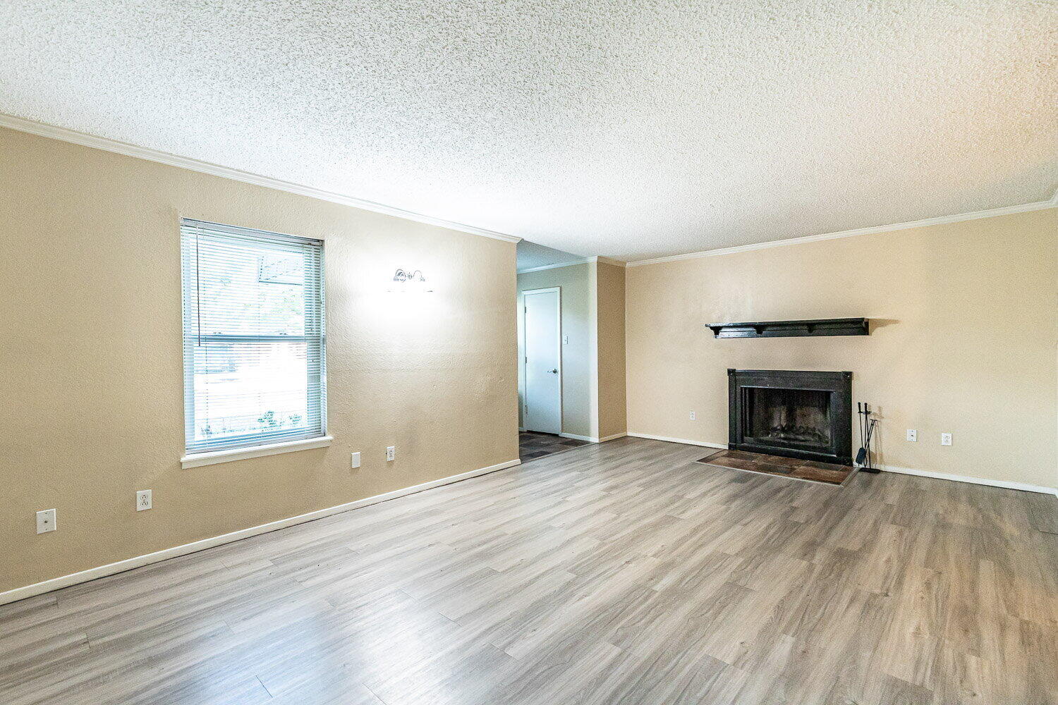 4737 48th Street Lubbock, TX 79414 - Photo 5 of 34 an empty room with windows and a fireplace