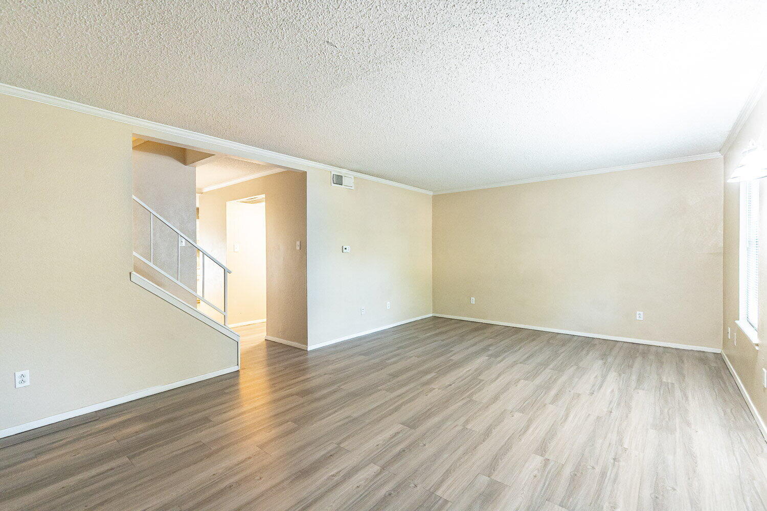 4737 48th Street Lubbock, TX 79414 - Photo 8 of 34 an empty room with wooden floor and windows