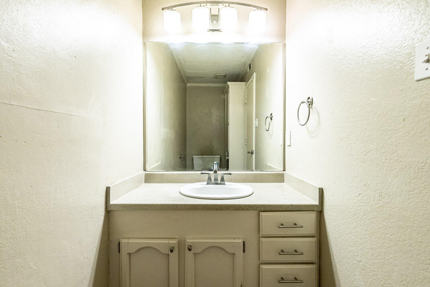 4737 48th Street Lubbock, TX 79414 - Photo 10 of 34 a bathroom with a sink and a mirror