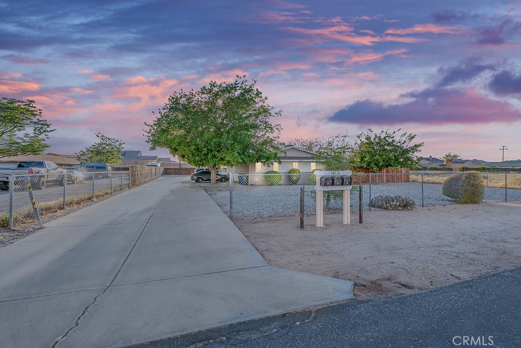 13250 Mohawk Road Apple Valley, CA 92308 - Photo 1 of 16 a view of a patio with a table and chairs