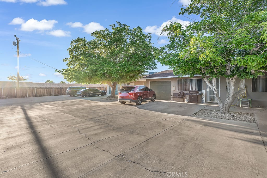 13250 Mohawk Road Apple Valley, CA 92308 - Photo 5 of 16 a couple of cars parked in front of a house