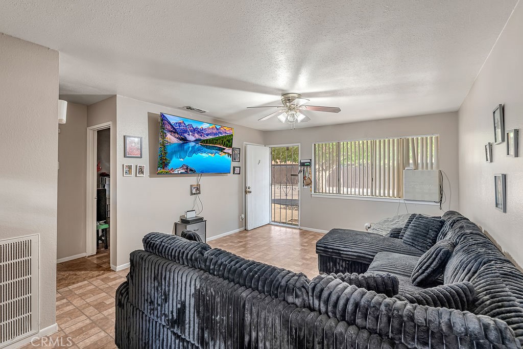 13250 Mohawk Road Apple Valley, CA 92308 - Photo 9 of 16 a living room with furniture and a flat screen tv