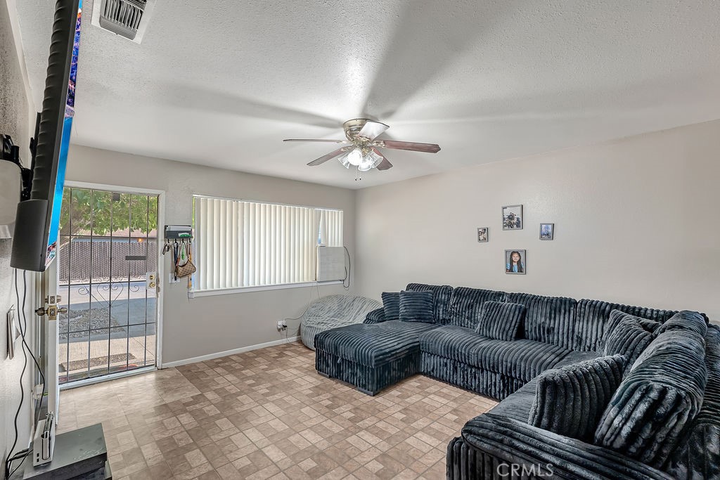 13250 Mohawk Road Apple Valley, CA 92308 - Photo 10 of 16 a living room with furniture and a large window