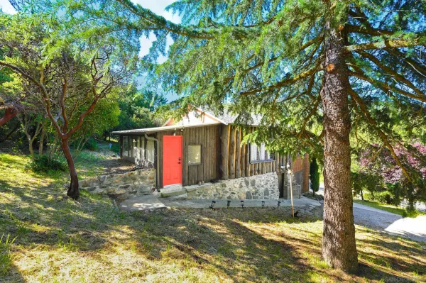 a view of a small house in the middle of a yard