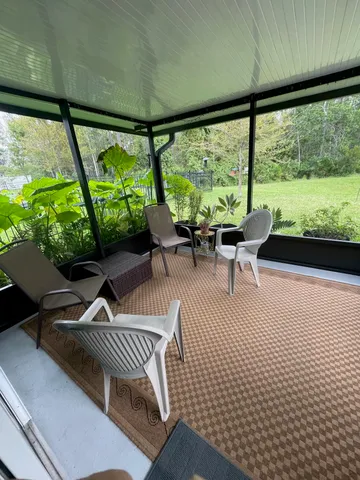 a building outdoor space with patio furniture and garden view