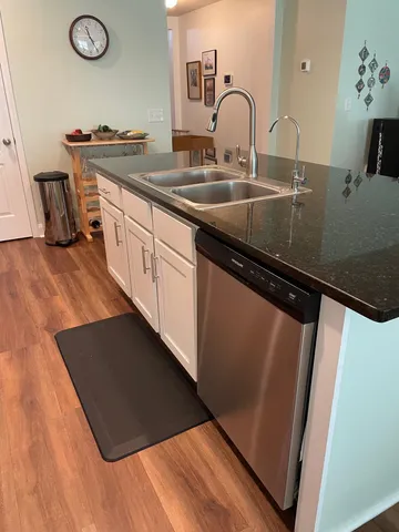a kitchen with sink a refrigerator and a stove