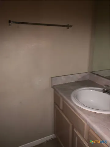 a bathroom with a sink and vanity