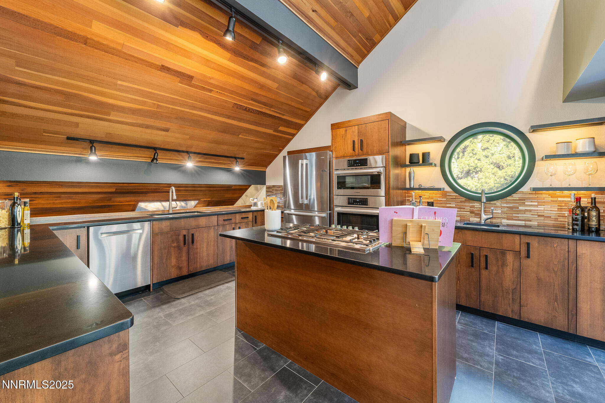 2521 Lake Ridge Shores Circle Reno, NV 89519 - Photo 15 of 54 a kitchen with lots of wooden cabinets a clock and a table