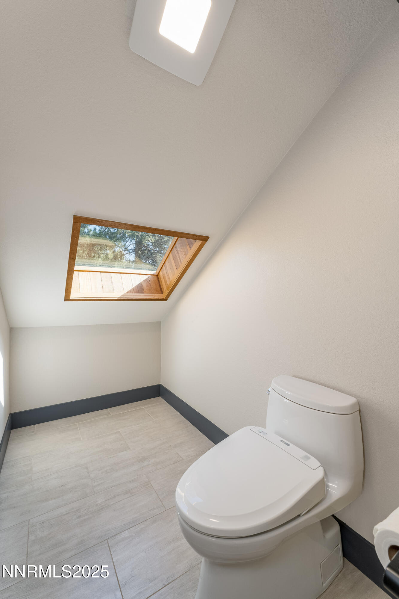 2521 Lake Ridge Shores Circle Reno, NV 89519 - Photo 38 of 54 a white toilet sitting next to a window