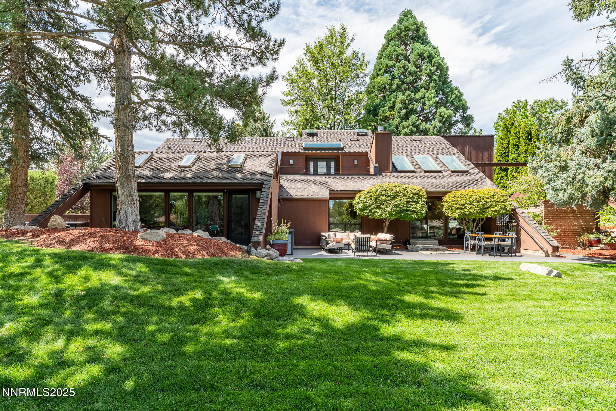 2521 Lake Ridge Shores Circle Reno, NV 89519 - Photo 40 of 54 a view of a house with a big yard and large trees