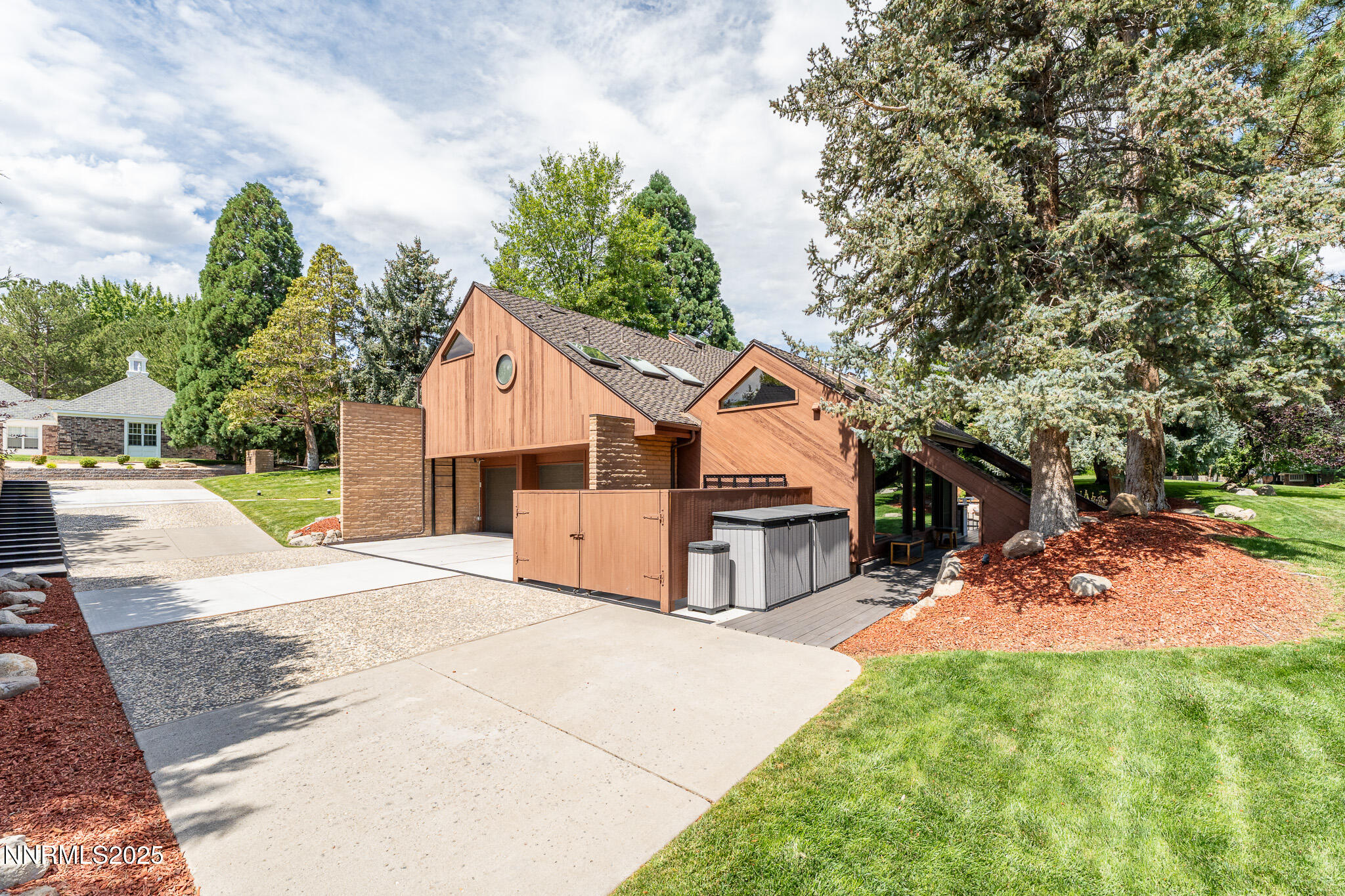 2521 Lake Ridge Shores Circle Reno, NV 89519 - Photo 44 of 54 a view of a white house with a yard and large tree