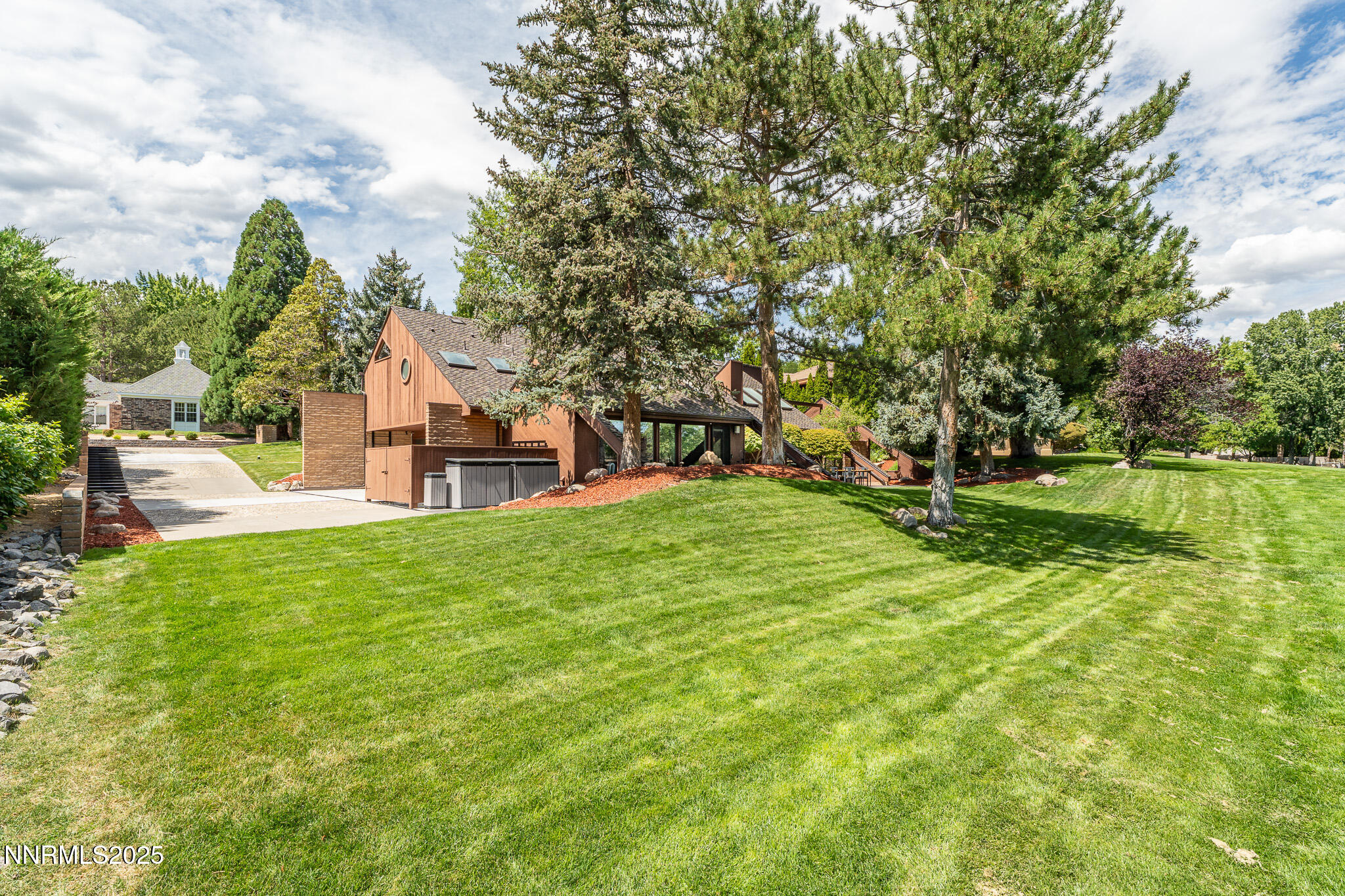 2521 Lake Ridge Shores Circle Reno, NV 89519 - Photo 46 of 54 a view of a house with a big yard potted plants and large tree