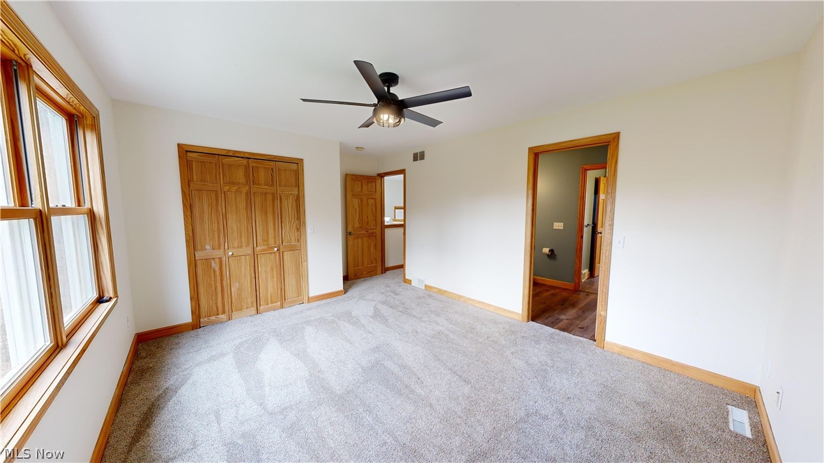 15548 Trask Road Thompson, OH 44086 - Photo 26 of 31 Third bedroom featuring light carpet, a closet, and ceiling fan
