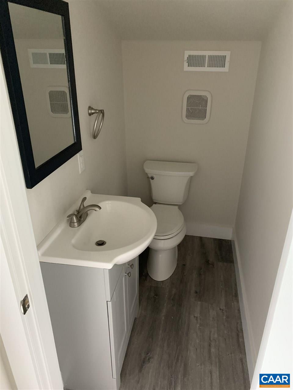 1109 Myrtle Street, Unit B Charlottesville, VA 22902 - Photo 11 of 14 a bathroom with a sink toilet and mirror