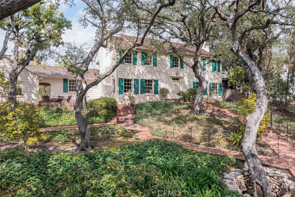 a front view of a house with a garden