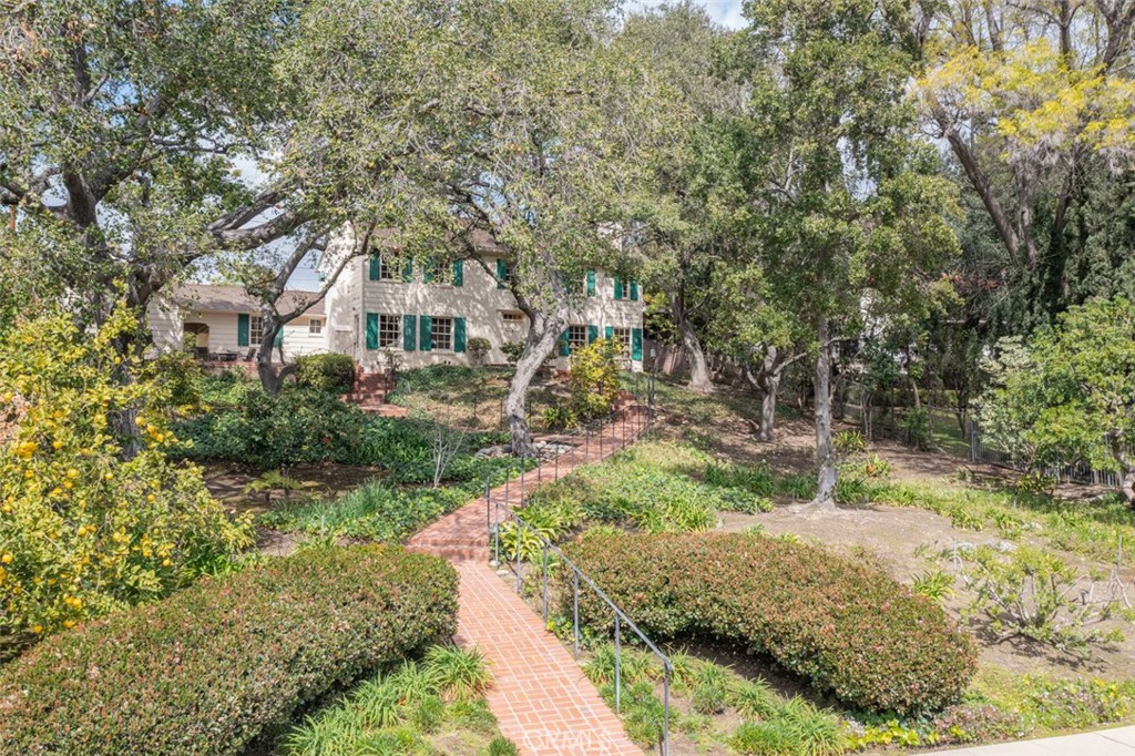 2435 Ridgeway Road San Marino, CA 91108 - Photo 2 of 38 a front view of a house with a yard and shrubs