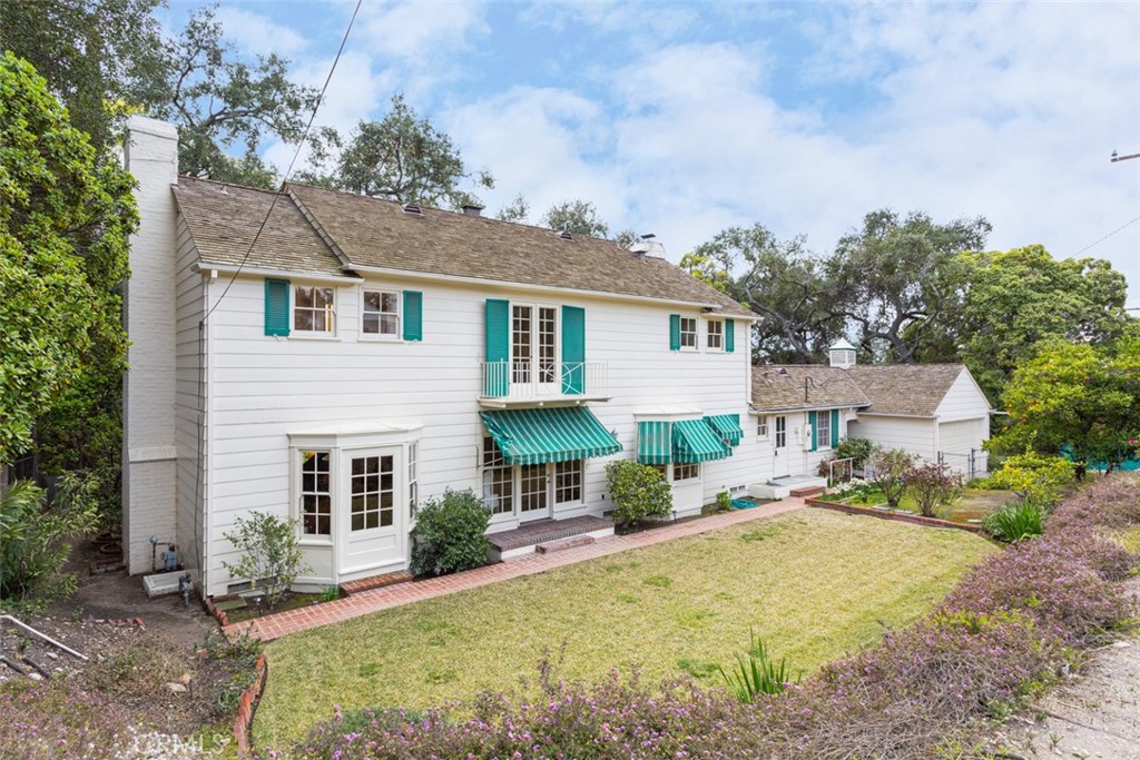 2435 Ridgeway Road San Marino, CA 91108 - Photo 30 of 38 a front view of a house with a garden and outdoor seating