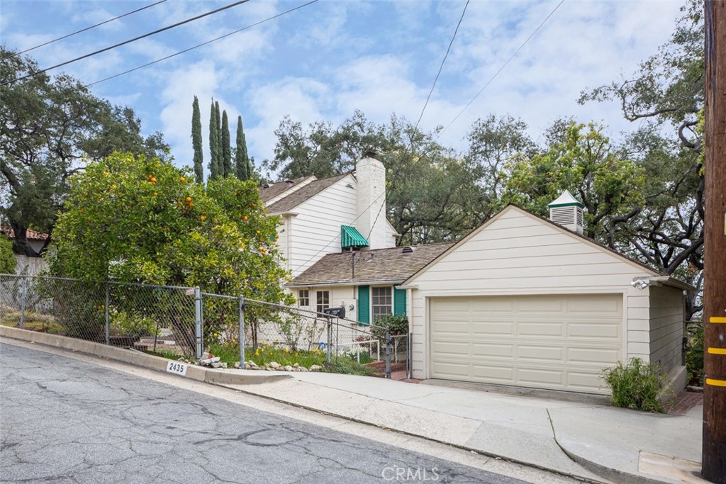 2435 Ridgeway Road San Marino, CA 91108 - Photo 31 of 38 a front view of a house with a garden and plants