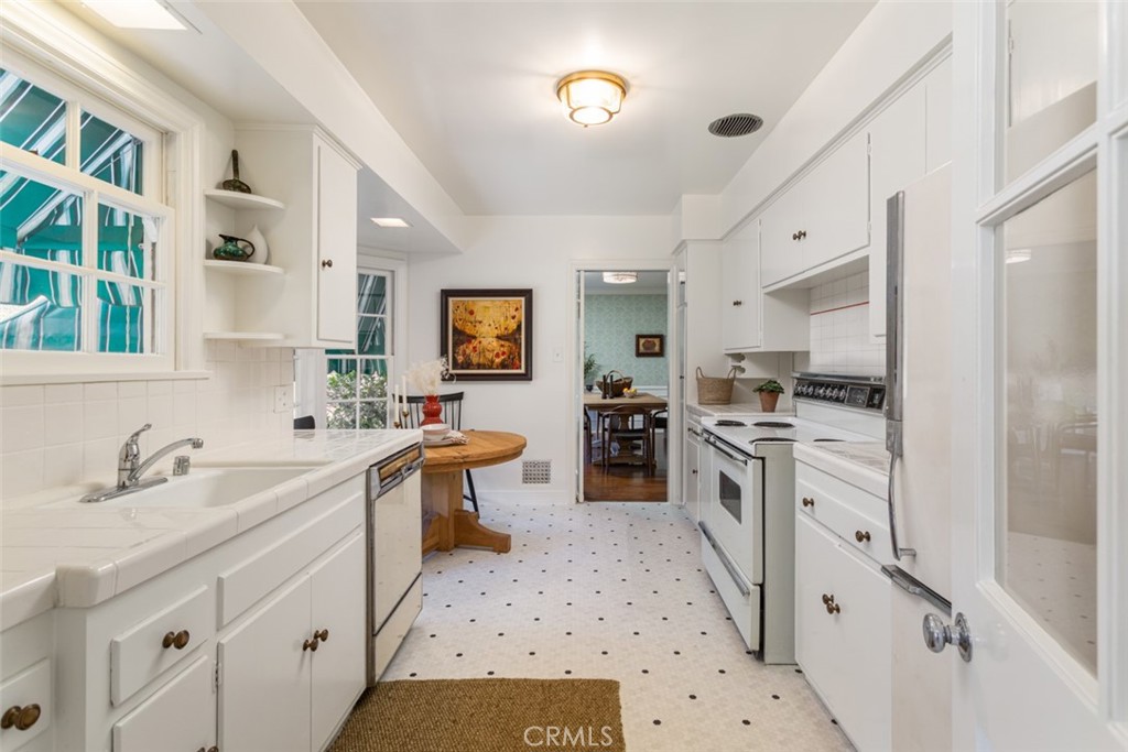 2435 Ridgeway Road San Marino, CA 91108 - Photo 9 of 38 a kitchen with white cabinets and appliances