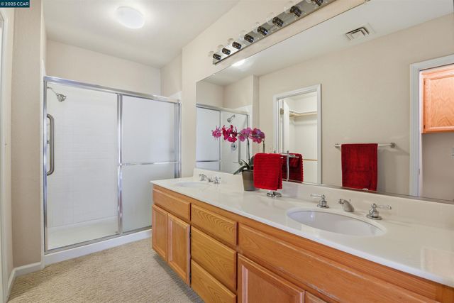 a bathroom with a double vanity sink mirror and double