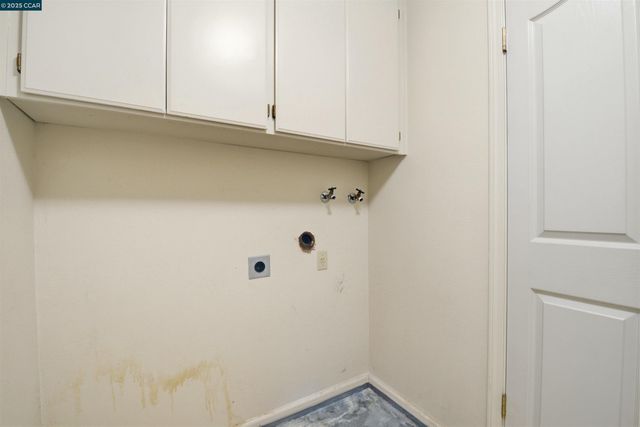 a view of a utility room with cabinets