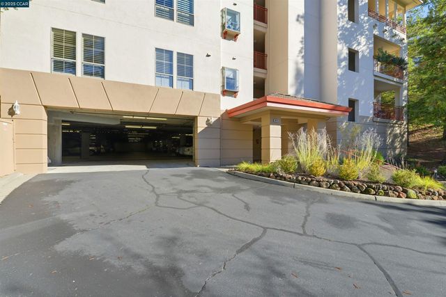 a view of a patio with a table and chairs and potted plants