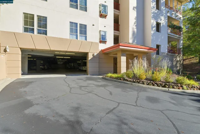 a view of a patio with a table and chairs and potted plants