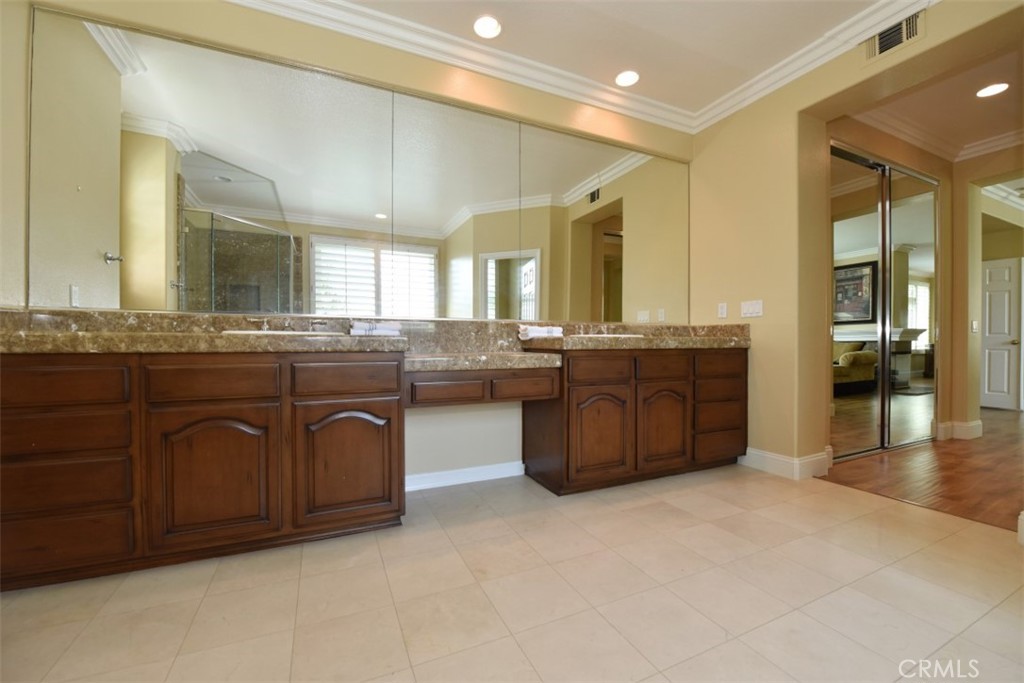 12 Brigadier Irvine, CA 92603 - Photo 37 of 50 a spacious bathroom with a granite countertop double vanity and a mirror