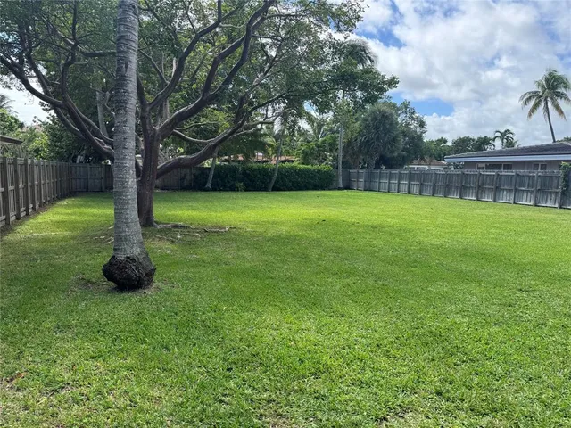 a backyard of a house with lots of green space