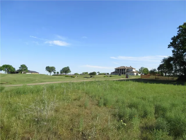a view of a field with an outdoor space and seating