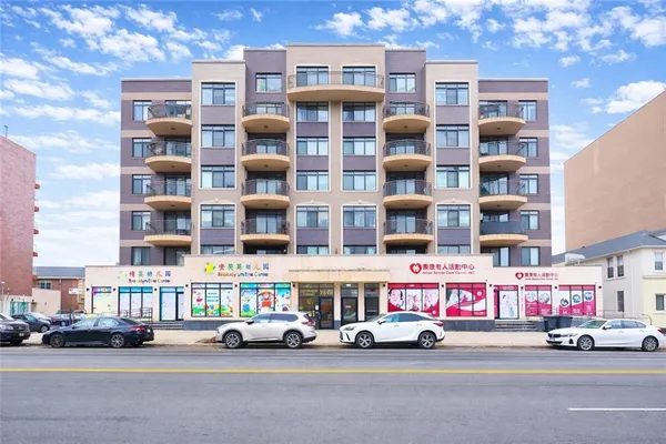 a view of a street with cars and buildings
