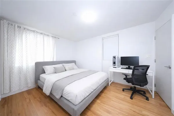 a bedroom with a bed and a chair