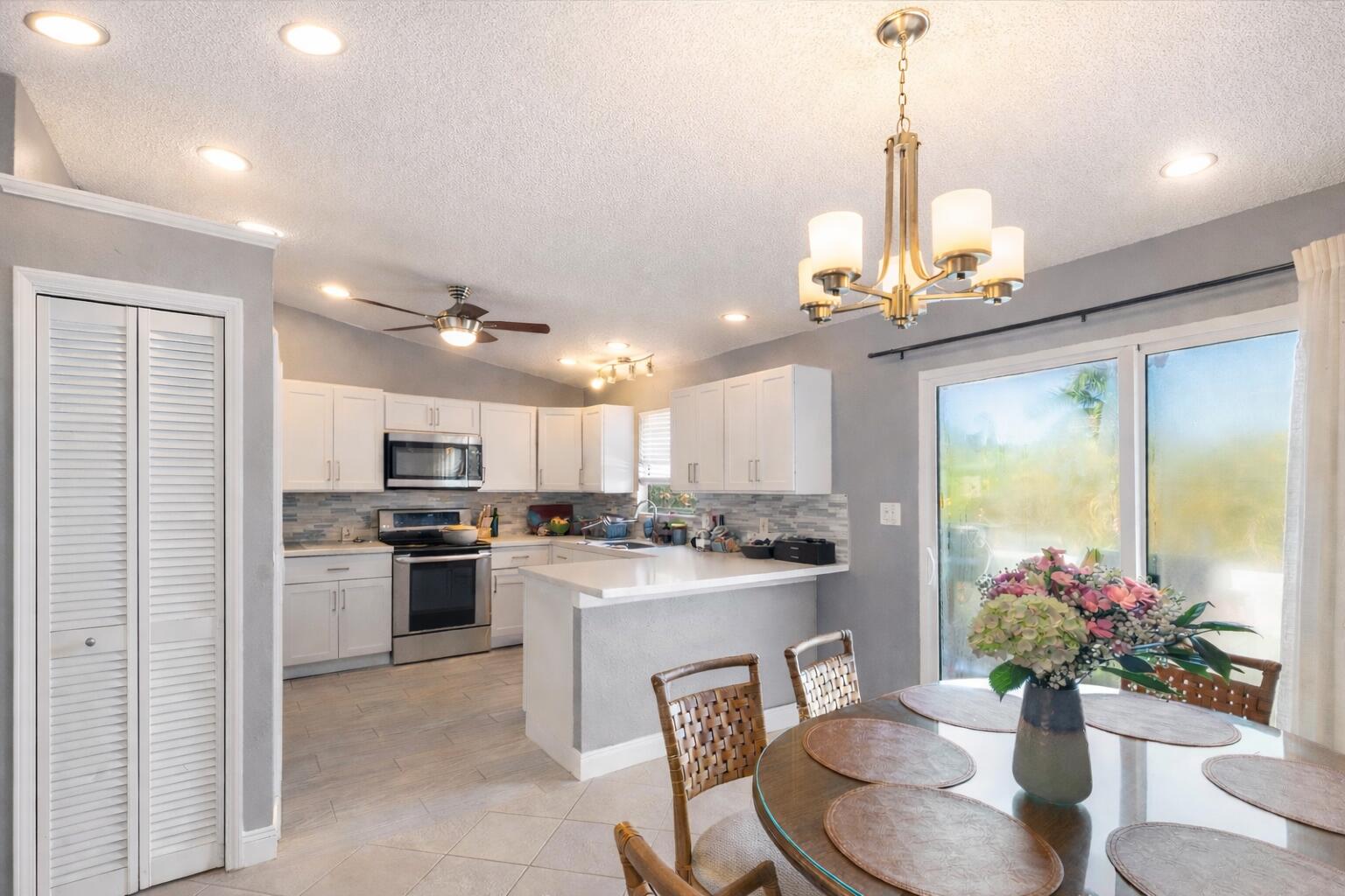 a kitchen with kitchen island granite countertop stainless steel appliances a sink stove and refrigerator