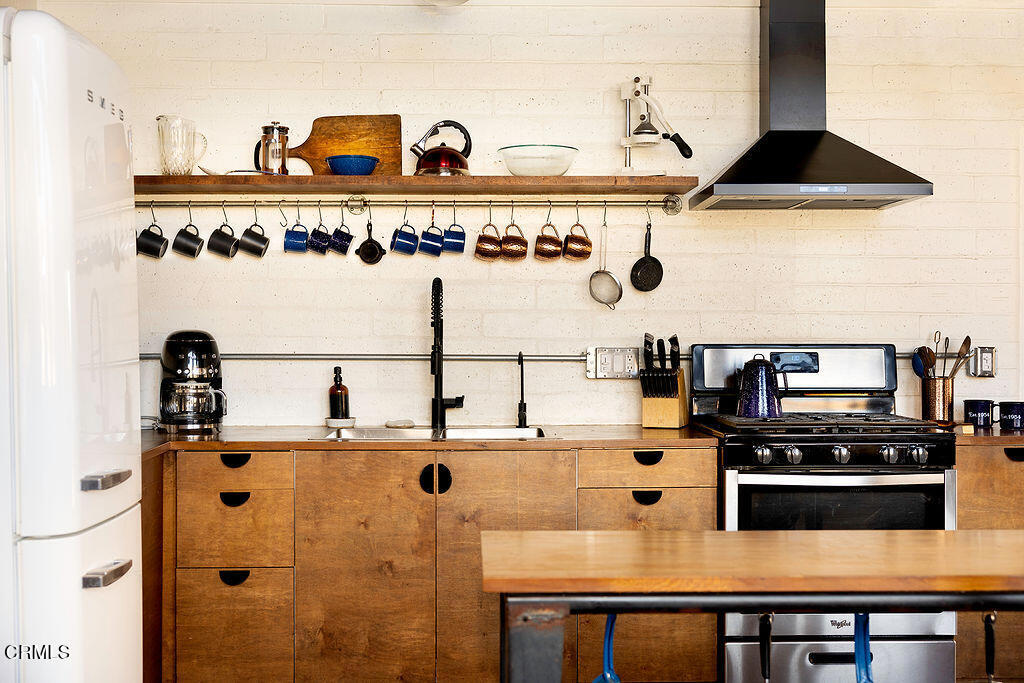 9427 T-Circle Drive Morongo Valley, CA 92256 - Photo 13 of 41 a kitchen with kitchen island stainless steel appliances a sink and a stove