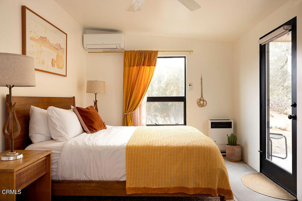 9427 T-Circle Drive Morongo Valley, CA 92256 - Photo 20 of 41 a bedroom with a bed and wooden floor