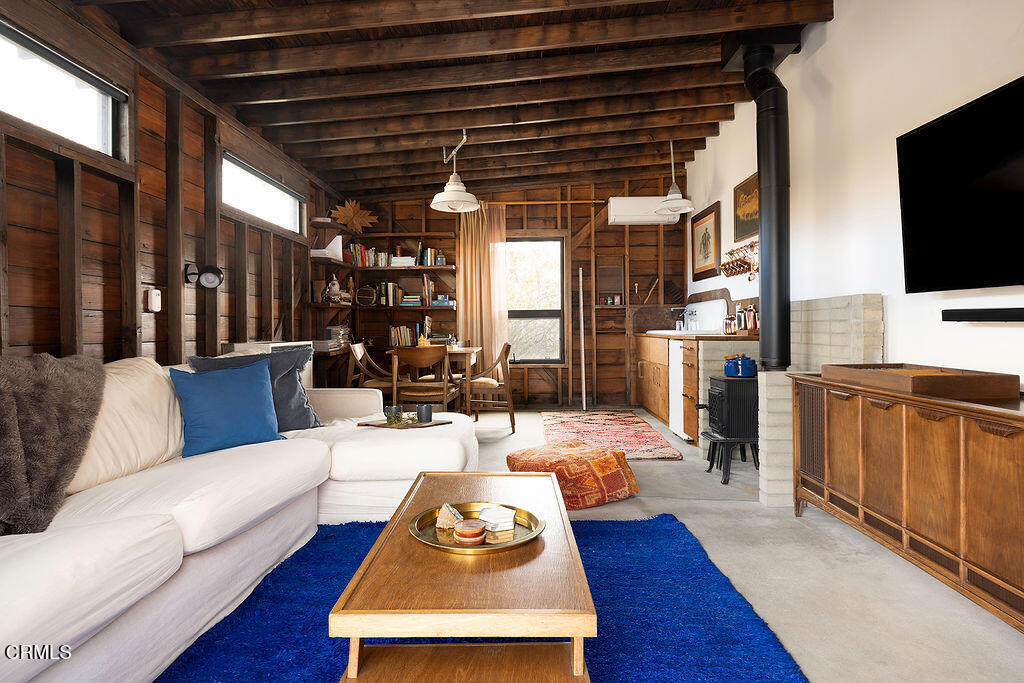 9427 T-Circle Drive Morongo Valley, CA 92256 - Photo 25 of 41 a living room with furniture and a flat screen tv