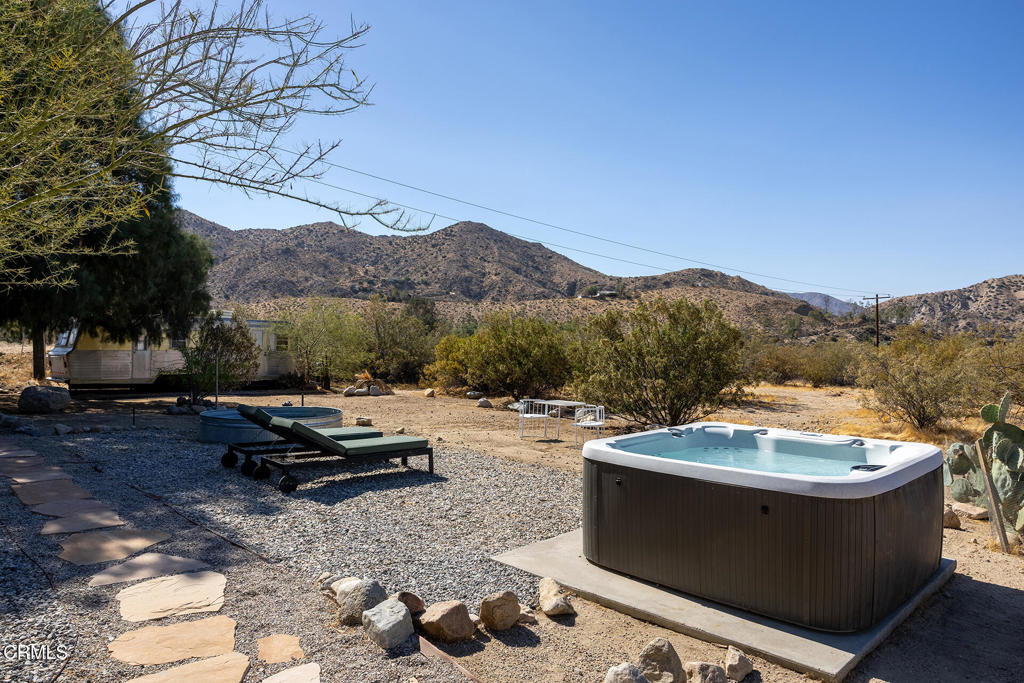 9427 T-Circle Drive Morongo Valley, CA 92256 - Photo 34 of 41 a view of a backyard with couches plants and large trees