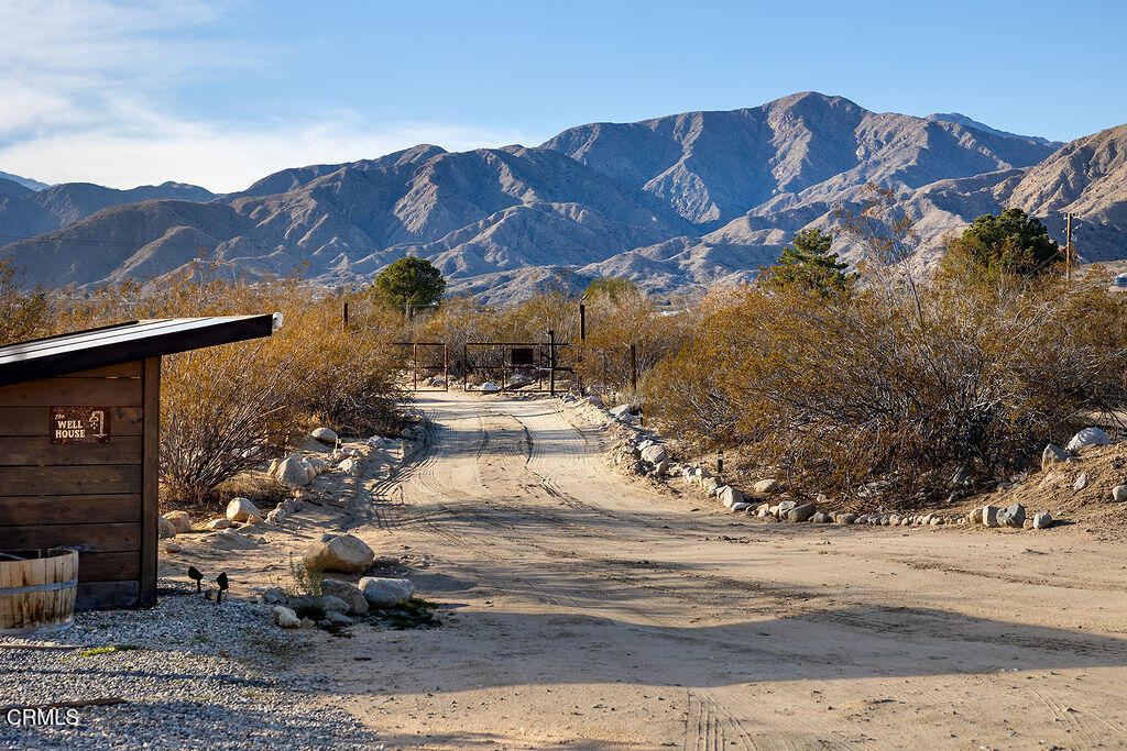 9427 T-Circle Drive Morongo Valley, CA 92256 - Photo 4 of 41 a view of a house with a yard and a wooden fence