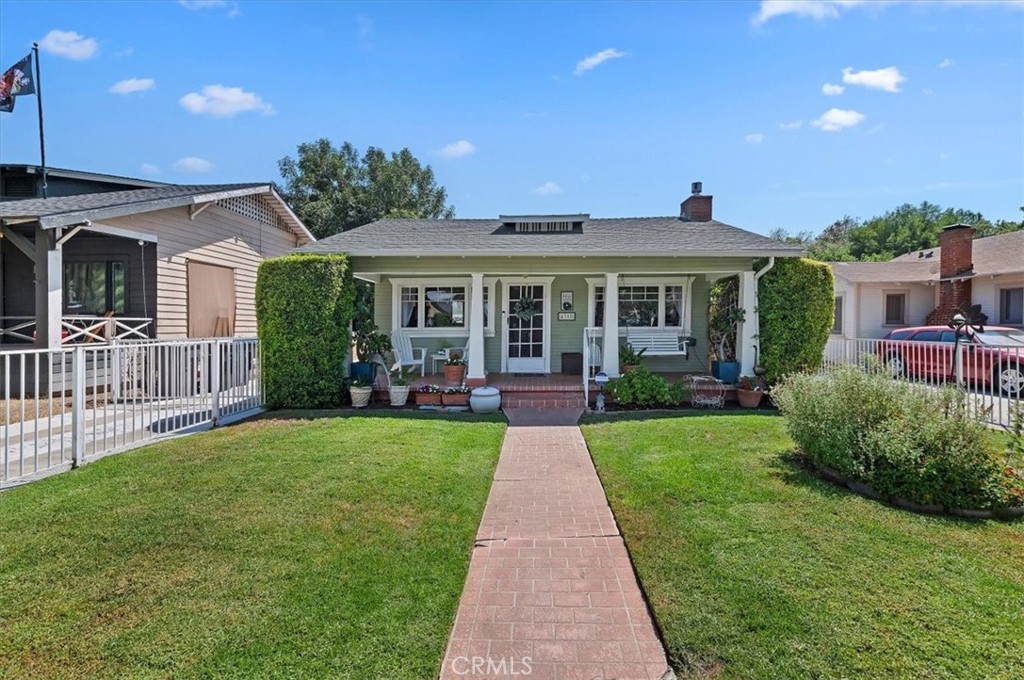4310 Edgewood Place Riverside, CA 92506 - Photo 1 of 1 a front view of a house with a yard table and chairs