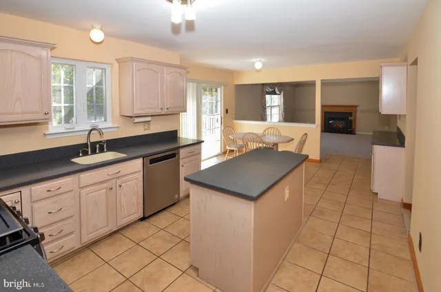 a kitchen with stainless steel appliances granite countertop a sink and a stove
