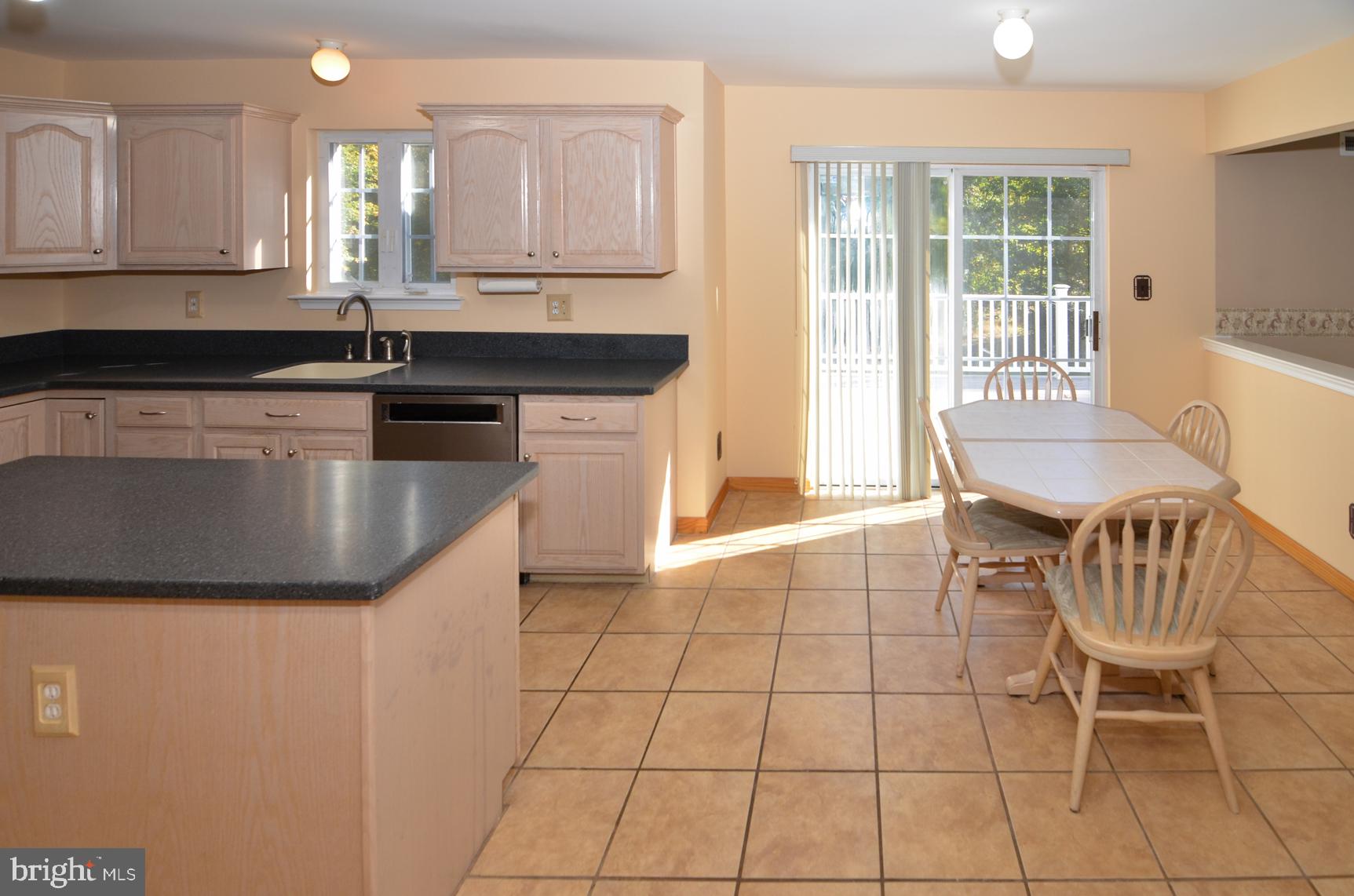 9 Noa Court Hamilton, NJ 08690 - Photo 16 of 47 a kitchen with kitchen island granite countertop a sink a stove a dining table and chairs