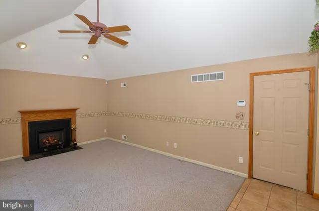 an empty room with closet and a fireplace