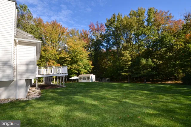 a white house with a yard and sitting area