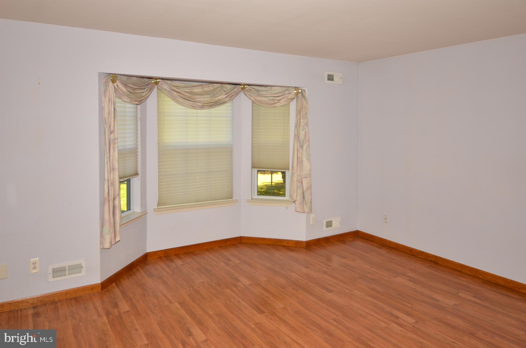 9 Noa Court Hamilton, NJ 08690 - Photo 9 of 47 an empty room with wooden floor and windows