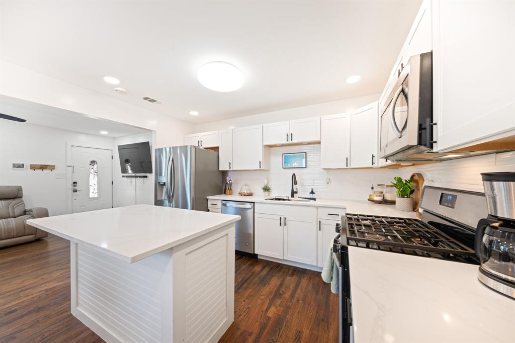 2114 Engle Avenue Dallas, TX 75224 - Photo 27 of 27 a kitchen with a sink a stove and cabinets
