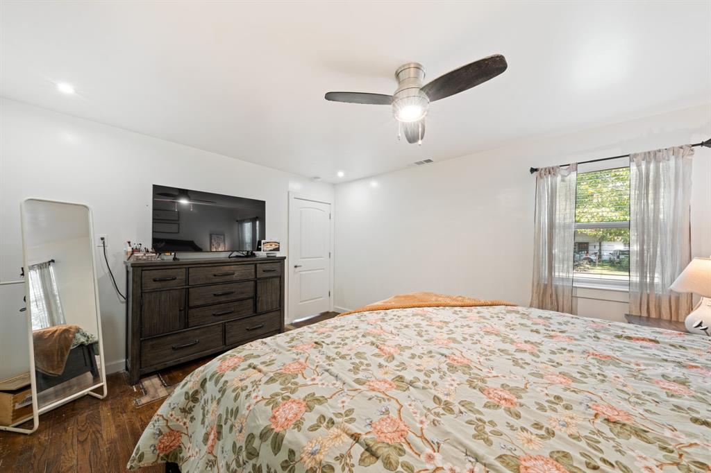 2114 Engle Avenue Dallas, TX 75224 - Photo 11 of 27 a bedroom with a bed and a flat screen tv