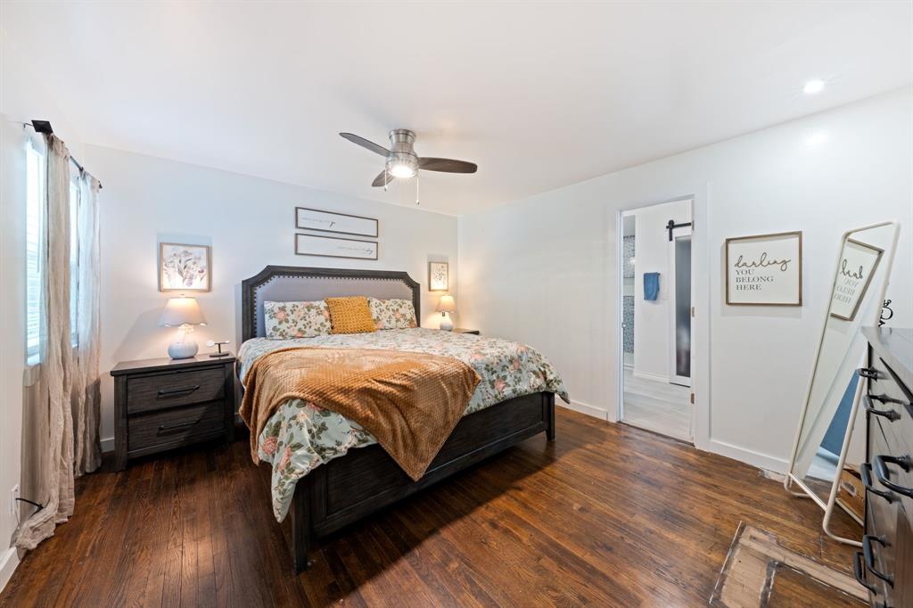 2114 Engle Avenue Dallas, TX 75224 - Photo 12 of 27 a bedroom with a bed and wooden floor