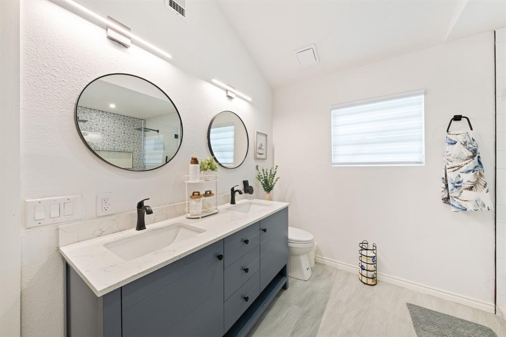 2114 Engle Avenue Dallas, TX 75224 - Photo 13 of 27 a bathroom with a double vanity sink mirror and a